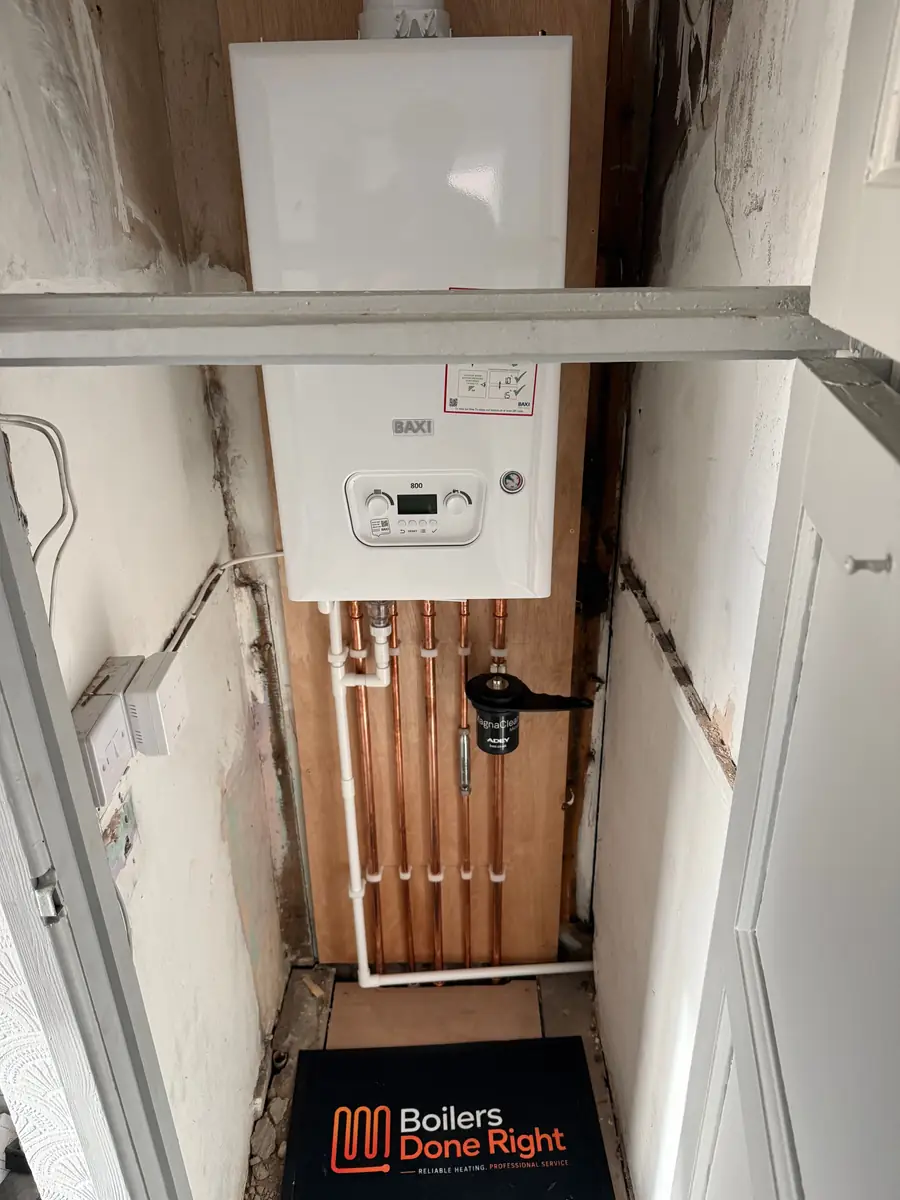 Baxi combi boiler installed in an alcove with neat copper pipework